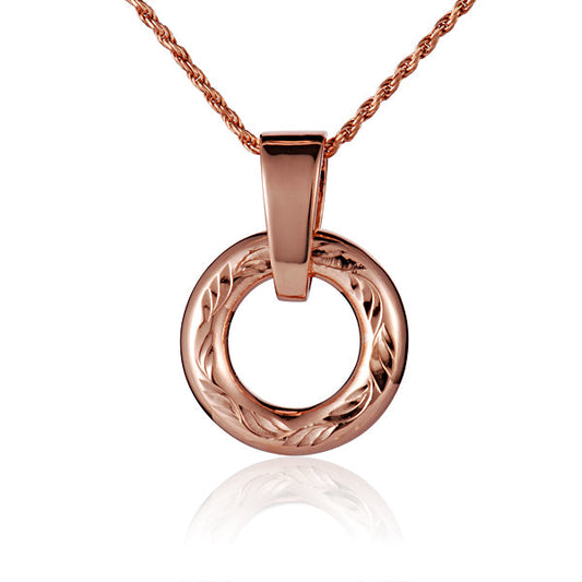 The picture shows a small rose gold vermeil round circle engraved pendant.