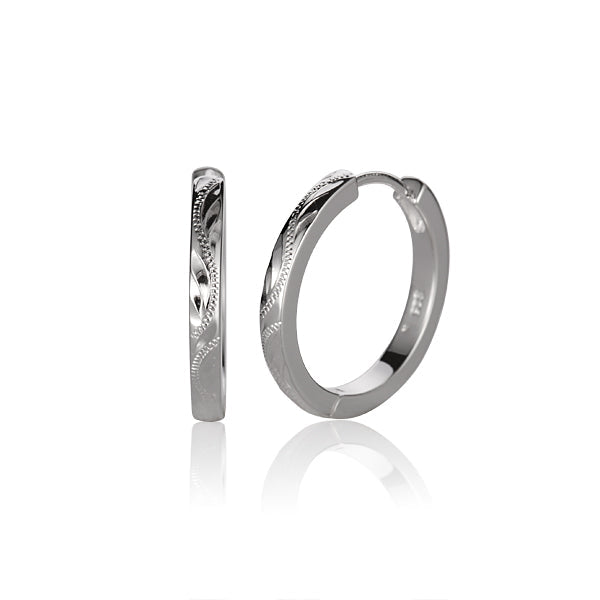 The picture shows a pair of sterling silver solid wire engraved round earrings in a large size.