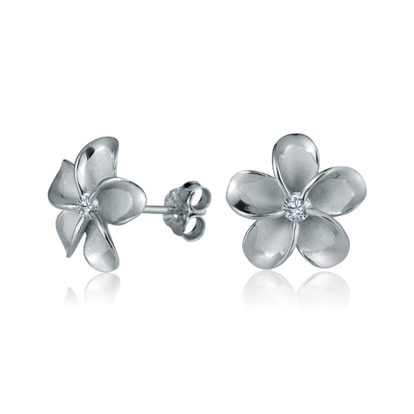 The photo show white gold vermeil sterling silver rhodium plated plumeria flower stud earrings with cubic zirconia stones in the center.  