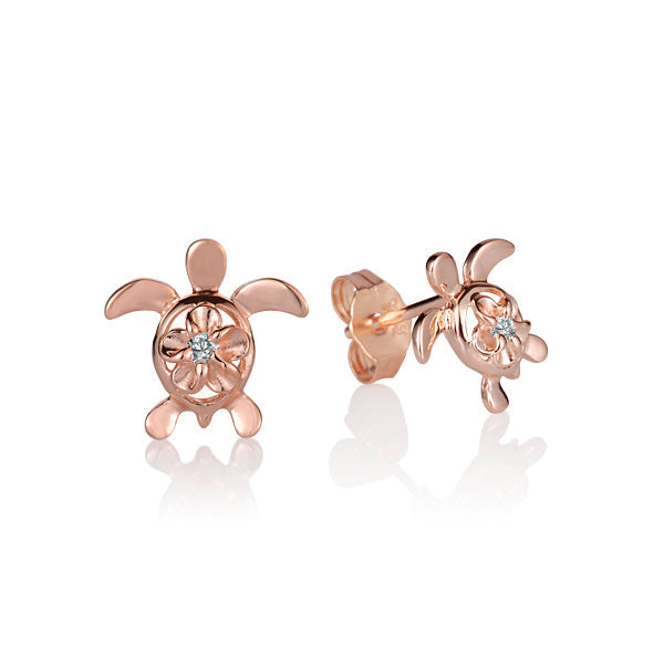 The photo shows a rose gold vermeil pair of sea turtle stud earrings featuring a plumeria motif with cubic zirconia. 
