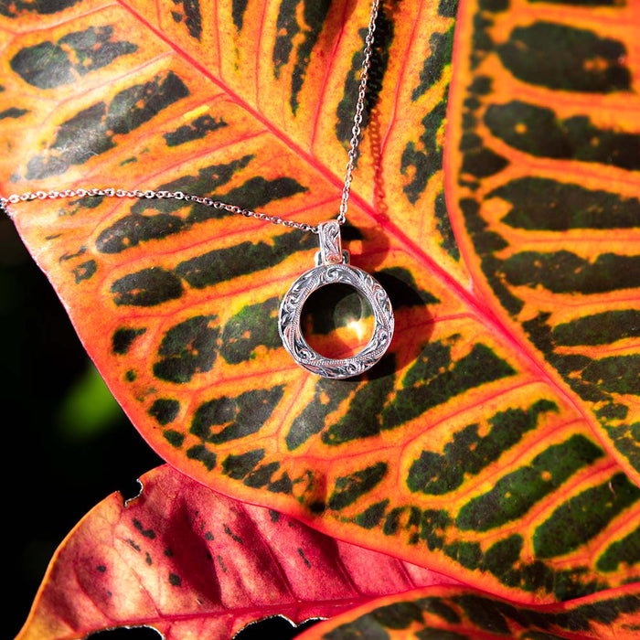Engraved sterling silver pendant featuring infinity circle design with traditional Hawaiian scroll or wave engraving all around the jewelry