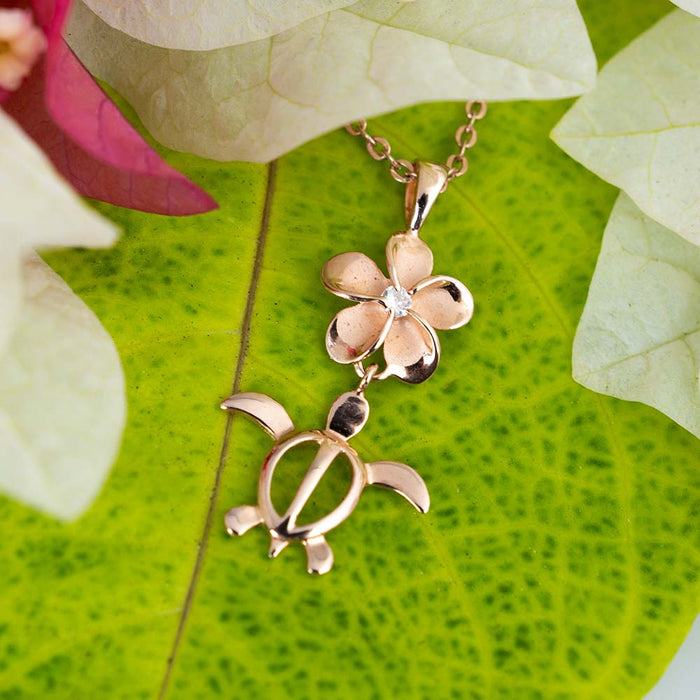 rose gold pendant featuring a sea turtle attached to a plumeria flower with a sustainable eco gem cubic zirconia in the middle