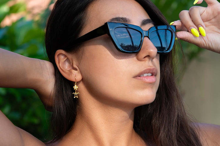 Holiday Gift Guide 2023 featuring plumeria & sea turtle hook earrings in yellow gold setting