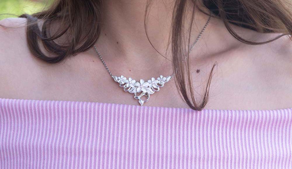 accessorizing 101 blog cover image featuring a plumeria cluster pendant