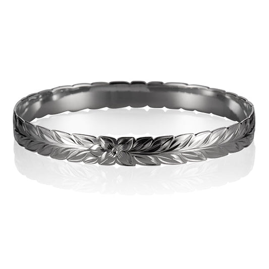 Sterling silver bangle engraved with plumeria flower and maile leaf.