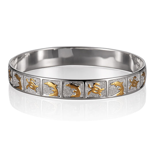 The photo shows a sterling silver two-tone yellow and white gold vermeil bangle with dolphins and sea turtle designs. 