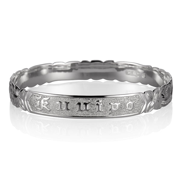 Sterling silver bangle with engraved plumeria motif, and the Hawaiian word "Ku'uipo" engraved.