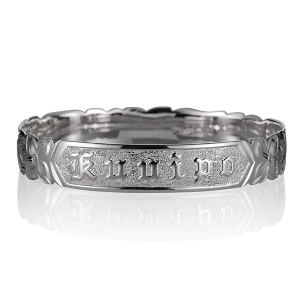 Sterling silver bangle with engraved plumeria motif, and the Hawaiian word "Ku'uipo" engraved.