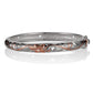 The picture shows a two-tone white and rose gold vermeil scroll oval open bangle. 