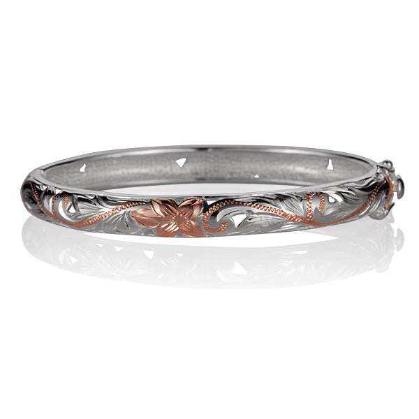 The picture shows a two-tone white and rose gold vermeil scroll oval open bangle. 