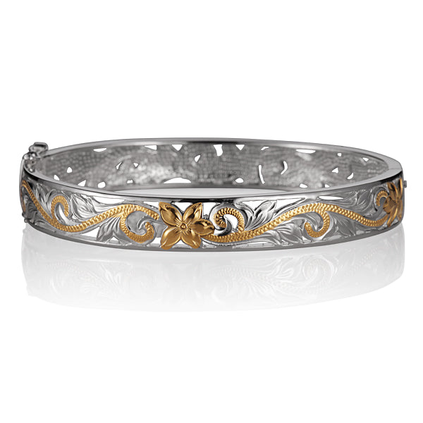 The photo is a sterling silver yellow gold vermeil plumeria scroll bangle.