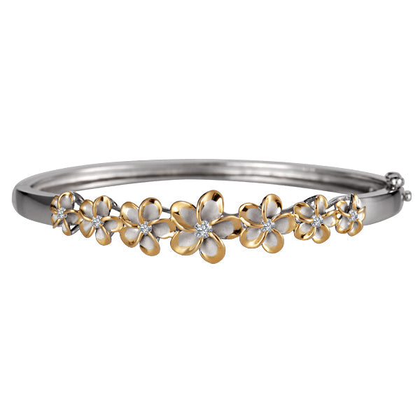 The picture is a two-tone sterling silver and yellow gold vermeil plumeria bangle with cubic zirconia. 