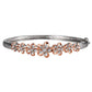 The photo shows a two-tone sterling silver and rose gold vermeil plumeria bangle with cubic zirconia. 