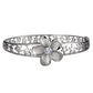 The photo shows a white gold vermeil sterling silver rhodium plated plumeria flower bangle featuring sea turtles and cubic zirconia stones.  