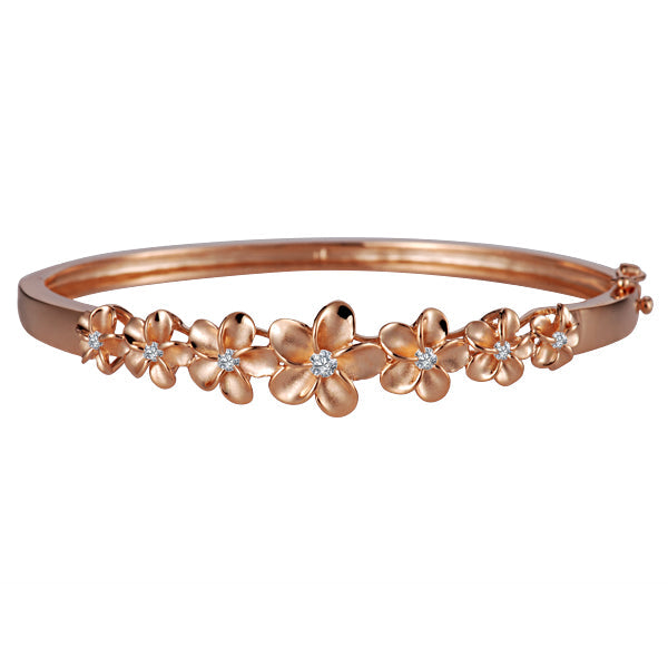 The photo shows a rose gold vermeil plumeria bangle with cubic zirconia. 