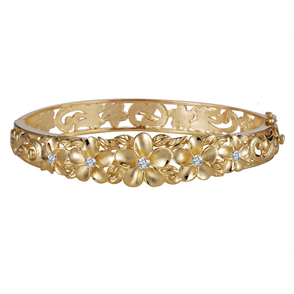 The photo shows a rhodium plated yellow gold vermeil plumeria bangle with cubic zirconia. 