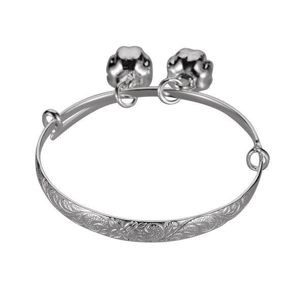 The photo shows a sterling silver baby scroll bangle with two bells.