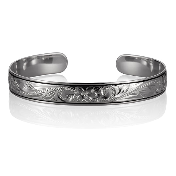 The photo shows a sterling silver cuff bangle with black borders featuring a Hawaiian scroll.