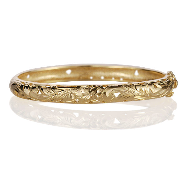 The photo shows a yellow gold vermeil scroll oval open bangle. 