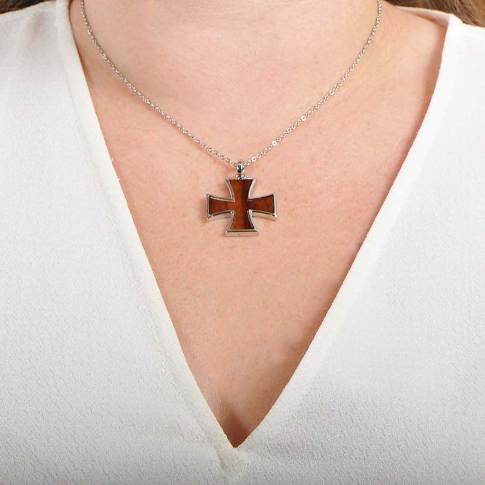 Sterling silver and Koa wood pendant. The pendant is designed to look like a greek cross. 