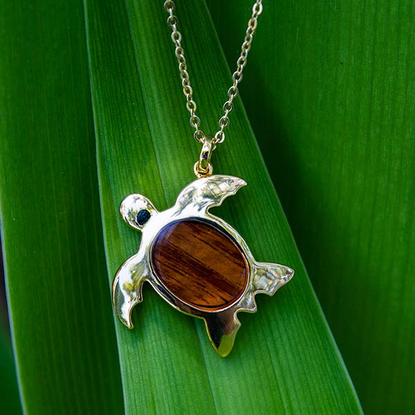Sterling Silver sea turtle pendant with a Koa Wood shell. 