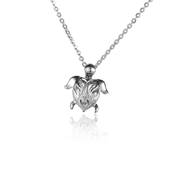 The photo is a small white gold vermeil turtle scroll pendant.