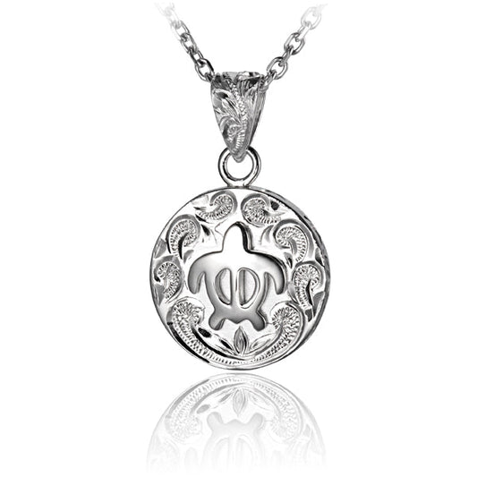 The photo shows a sterling silver sea turtle medallion pendant featuring a scroll motif.