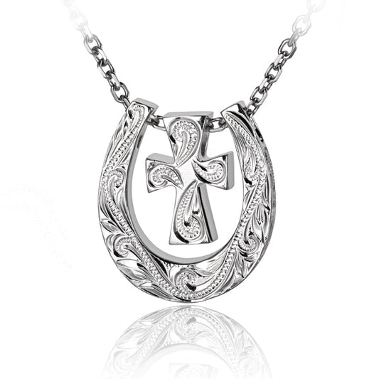 The photo shows a white gold vermeil scroll horse shoe pendant featuring a cross design.