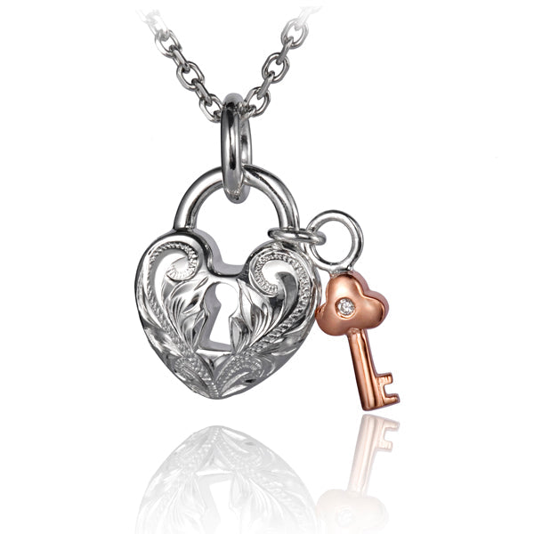 The picture shows a white and rose gold vermeil scroll heart with key pendant.