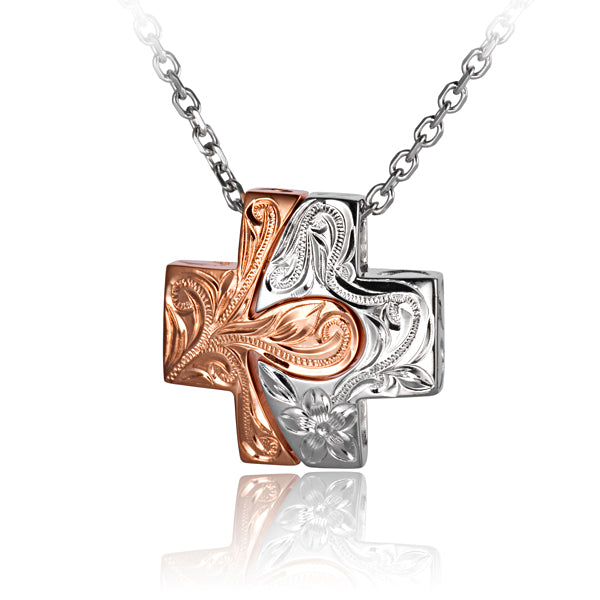 The photo shows a sterling silver and rose gold vermeil cross pendant featuring a Hawaiian scroll design. 