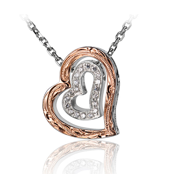 The photo shows a 925 sterling silver two-tone scroll heart pendant featuring clear eco-gems. 