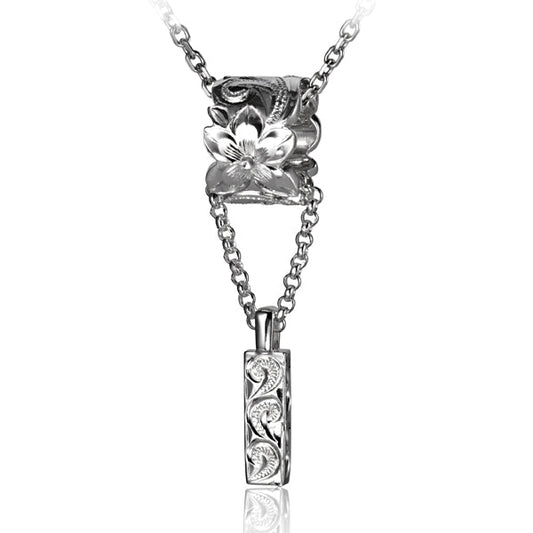 The photo is a sterling silver plumeria scroll barrel featuring a wave scroll bar pendant. 