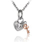 The picture shows a white and rose gold vermeil scroll heart with key pendant with cubic zirconia.