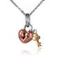 The picture shows a rose gold vermeil scroll heart with a yellow gold vermeil key pendant with cubic zirconia.
