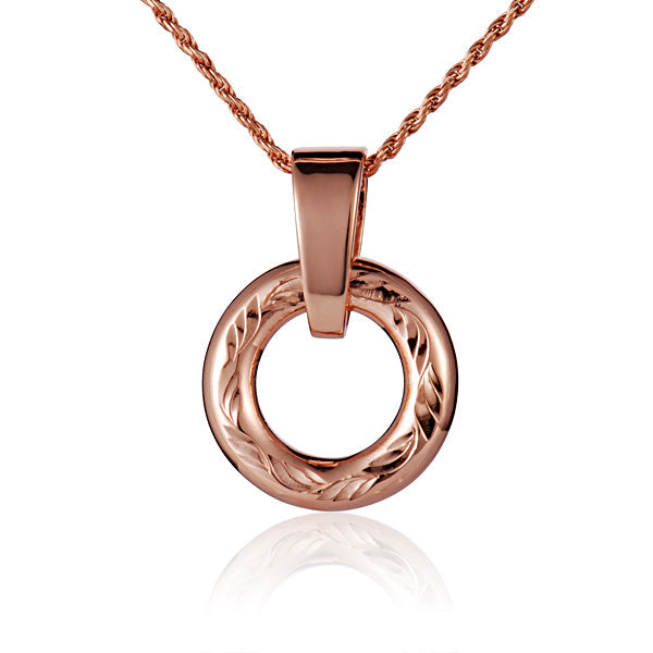 The picture shows a small rose gold vermeil round circle engraved pendant. 