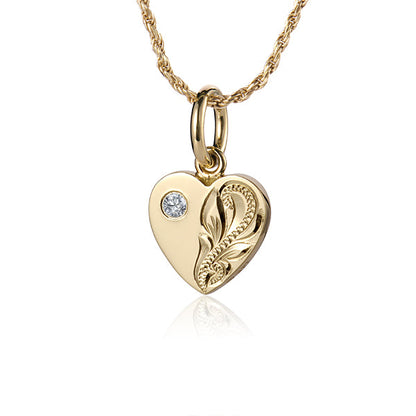 The photo shows a 14K yellow gold heart engraved pendant with cubic zirconia.
