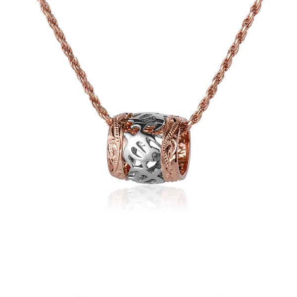 The photo shows a 14K two-tone gold sea turtle scroll edge barrel pendant.