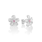 The photo is a pair of matte finish sterling silver white gold vermeil plumeria stud earrings with pink cubic zirconia stones.