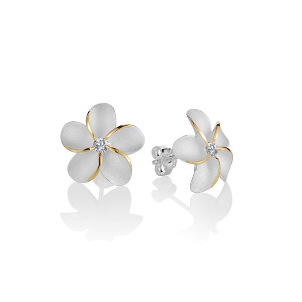 The photo is a pair of matte finish sterling silver yellow gold vermeil plumeria stud earrings with cubic zirconia. 