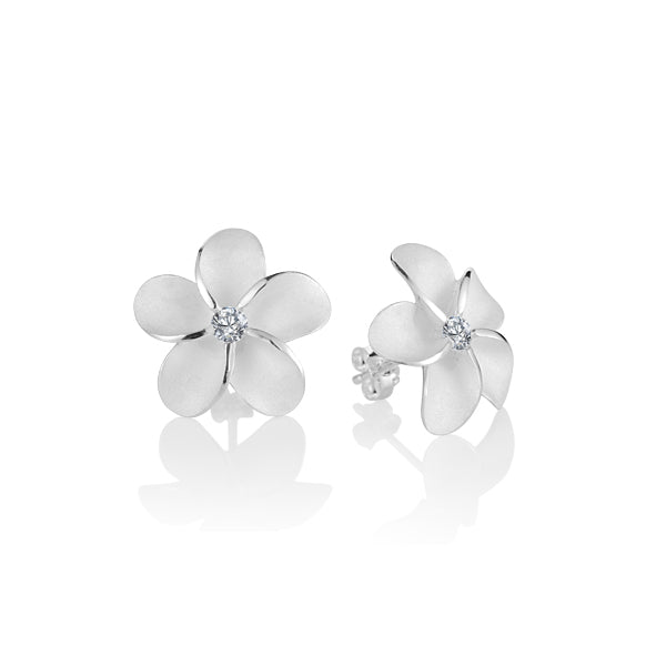 The picture is a pair of matte finish sterling silver white gold vermeil plumeria stud earrings with cubic zirconia gems. 