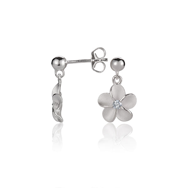 The photo shows a pair of white gold vermeil plumeria stud earrings with cubic zirconia. 
