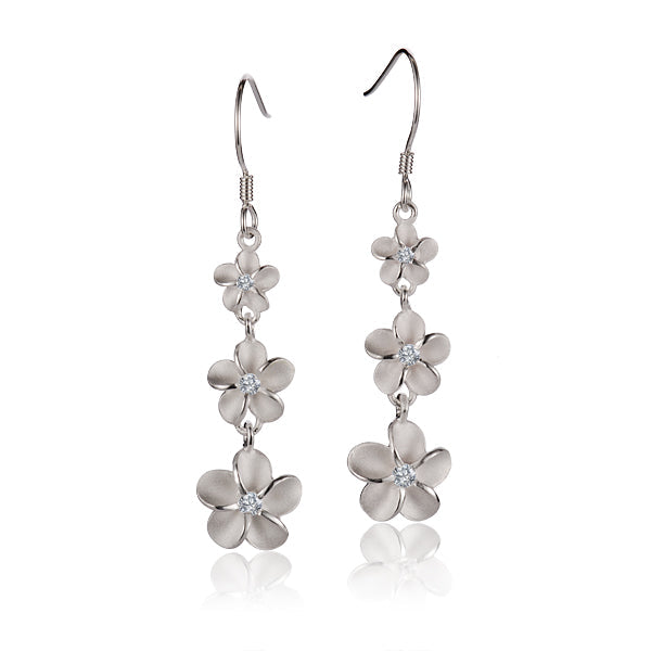 The photo shows a pair of sterling silver matte finish plumeria hook earrings with cubic zirconia.