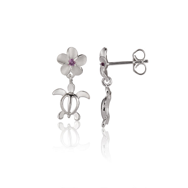 The picture has a pair of 6 mm plumeria and sea turtle sterling silver stud earrings with a purple cubic zirconia gem.