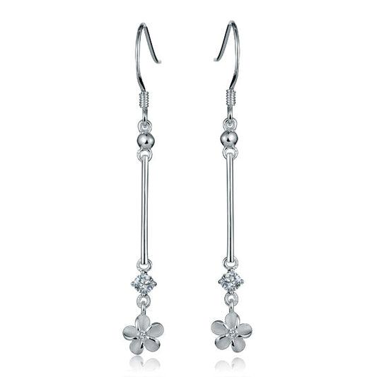 The photo shows a pair of sterling silver dangle bar earrings featuring a plumeria design with cubic zirconia.