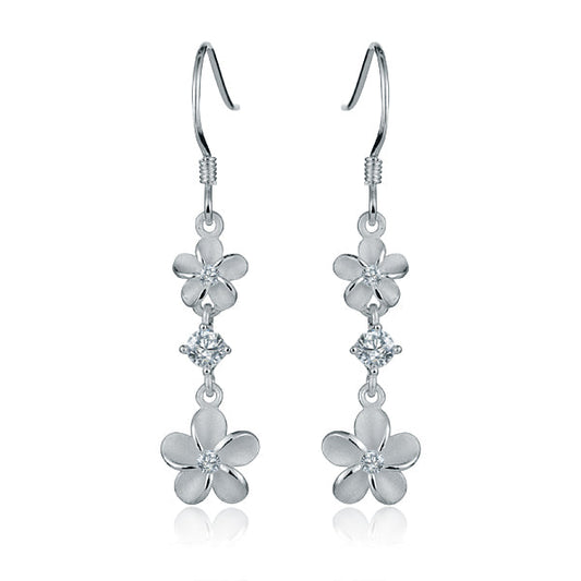 The photo shows a pair of sterling silver 2 plumeria hook earrings with cubic zirconia gems. 