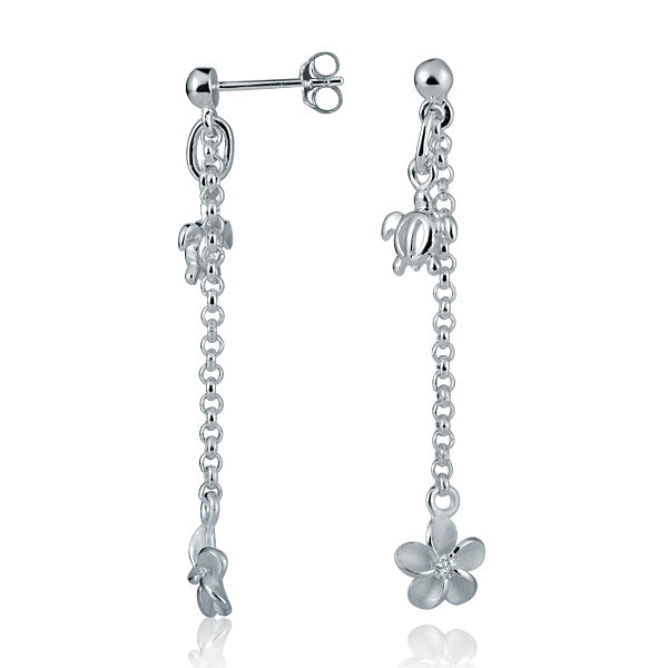 The photo shows a pair of sterling silver plumeria dangle earrings with sea turtle charms and cubic zirconia.