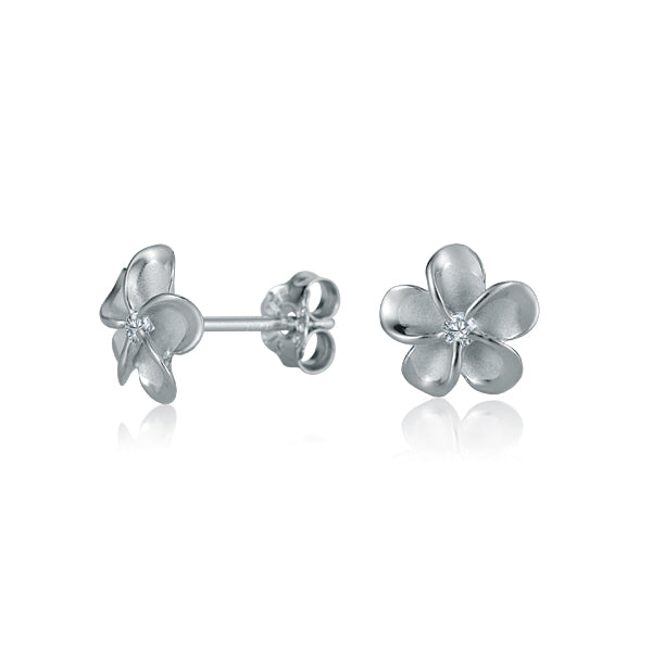 The photo shows a pair of white gold vermeil sterling silver rhodium plated plumeria stud earrings with cubic zirconia. 