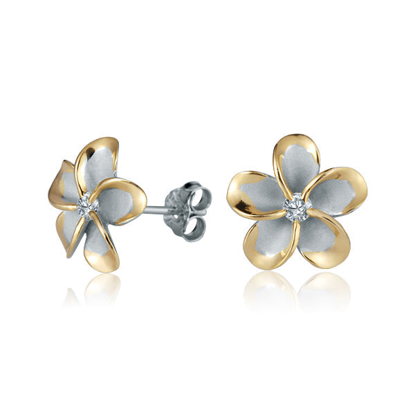 The photo shows a pair of yellow gold vermeil sterling silver rhodium plated plumeria flower stud earrings with cubic zirconia stones in the center.
