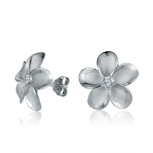 The photo show white gold vermeil sterling silver rhodium plated plumeria flower stud earrings with cubic zirconia stones in the center.  