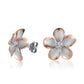 The photo show rose gold vermeil sterling silver rhodium plated plumeria stud earrings with cubic zirconia gems.